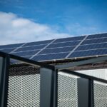 Een zelfstandige ondernemer die zonnepanelen en een thuisbatterij installeert voor off-grid energieoplossingen.